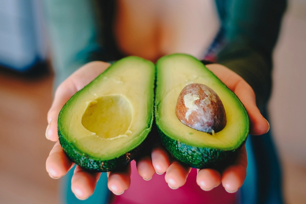 Woman Holding Avocados for Flush Toxins and Keep Kidneys ￼Strong