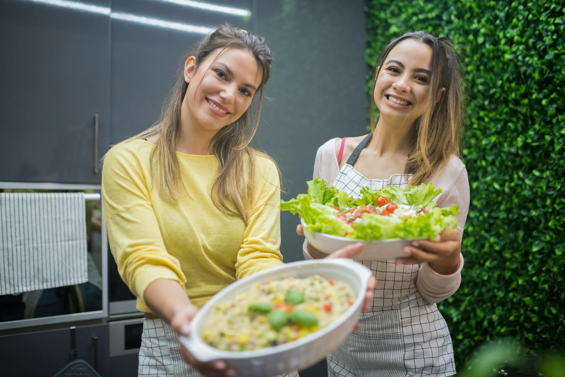 How to naturally detoxify your body - women holding bowls of vegetable salad